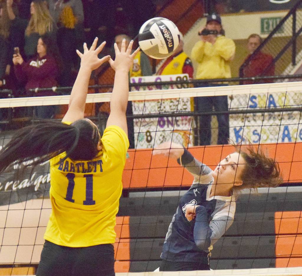 Soldotna senior Aliann Schmidt (right) sends a ball at the hands of Bartletts Liu Paia Togagae Thursday at the Class 4A state volleyball tournament at West High School. (Photo by Joey Klecka/Peninsula Clarion)