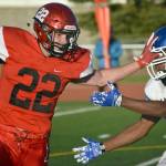 Kenai Centrals Titus Riddall wards off Palmers Morgan Freeman on Friday, Aug. 24, 2018, at Ed Hollier Field in Kenai. (Photo by Jeff Helminiak/Peninsula Clarion)