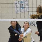 Nikiski teammates Angela Druesedow (left) and Kelsey Clark team up for a dig Saturday against Kenai Central at the Shayna Pritchard Memorial tournament at Nikiski High School. (Photo by Joey Klecka/Peninsula Clarion)
