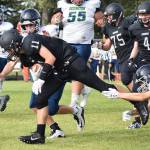Nikiski junior Michael Eiter (11) slips through a tackle Friday against the Redington Huskies at Nikiski High School. (Photo by Joey Klecka/Peninsula Clarion)