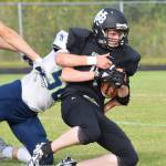 Nikiski sophomore Dylan Harris is tackled by Redingtons Eli Benson (50) Friday at Nikiski High School. (Photo by Joey Klecka/Peninsula Clarion)