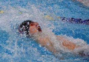 Kenai Centrals Savaii Heaven races to the third-place finish in the boys 100-yard backstroke Nov. 4, 2017, at the ASAA First National Bank State Swimming & Diving Championships at the Bartlett High pool. (Photo by Joey Klecka/Peninsula Clarion)