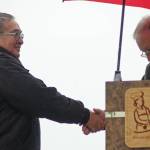 Rep. Mike Chenault, R-Nikiski (right) shakes hands with Kenai commercial fisherman Coby Wilson while presenting him and his wife Connie Wilson with an award at Industry Appreciation Day on Saturday, Aug. 25, 2018 in Kenai, Alaska. (Photo by Elizabeth Earl/Peninsula Clarion)