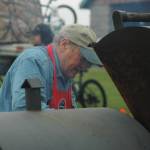 United Cook Inlet Drift Association President Dave Martin grills salmon for attendees at Industry Day on Saturday, Aug. 25, 2018 in Kenai, Alaska. (Photo by Elizabeth Earl/Peninsula Clarion)