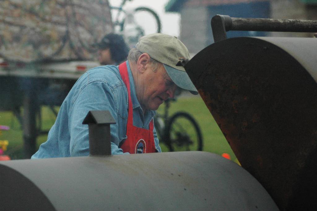 United Cook Inlet Drift Association President Dave Martin grills salmon for attendees at Industry Day on Saturday, Aug. 25, 2018 in Kenai, Alaska. (Photo by Elizabeth Earl/Peninsula Clarion)