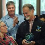 Sen. Peter Micciche, R-Soldotna (right) thanks Maggie Winston, the chair of the Governors Council on Disabilities and Special Education, for an award the board presented to him for his work on Senate Bill 174 during a signing ceremony for the bill at Hope Community Resources building on Saturday, Aug. 25, 2018 in Soldotna, Alaska. (Photo by Elizabeth Earl/Peninsula Clarion)