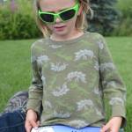 Silas Reising, 4, holds Alaskas Dinosaurs and Other Cretaceous Creatures, a book written by his grandmother, Janet Klein, and mother, Deborah Klein, at Bishops Beach, Homer, Alaska, on Aug. 9, 2018. Not shown is Kai Reising, 6. Sylas and his older brother Kai were the inspiration for the Kleins color and learn book. (Photo by Michael Armstrong/Homer News)