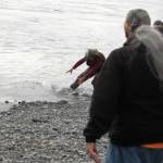 An angler leaps to a fellow anglers aid in tryping to pin down a rambunctious silver salmon the bank of the Kenai River at Cunningham Park on Wednesday, Aug. 30, 2018 in Kenai, Alaska. (Photo by Elizabeth Earl/Peninsula Clarion)