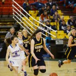 Homer junior Madison Akers grabs a steal and rushes down the court for a layup midway in the second half against ACS, Friday at the Sullivan Arena. The Mariners lost 34-23.