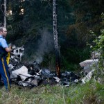 Wreckage of a small plane smolders in the woods on Saturday, August 22, 2015 at a crash site near South Cohoe Loop Road in Kasilof, Alaska.