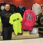 Heidi Hanson, team manager Nate Kiel & Brown Bear Zack Zulkanycz show the cool stuff available at the Bears Den.