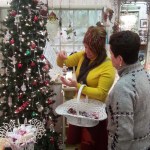 Ben Boettger/Peninsula Clarion Sarah Spencer tries on a skirt at the Black Friday Holiday Bazaar at the Kenai Challenger Learning Center on Saturday, Nov. 29.