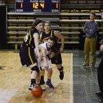Homer juniors Madison Akers (front) and Aurora Waclawski trap an ACS player against the sidelines in Friday's matchup against the Lions at the Sullivan Arena. Homer lost 34-23.