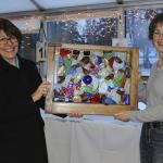 Mary Krull & Mary Green display a donated auction item.