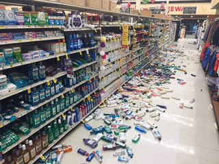 Robin and Shannon Muster relax with their daughter, six-year-old Effie, in a temporary shelter after being evacuated from their home on Lilac Lane on Sunday, Jan. 24, 2016 at the Kenai National Guard Armory in Kenai, Alaska. A 7.1 magnitude earthquake caused gas explosions on Lilac Lane.