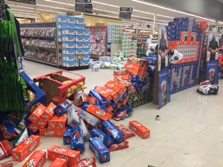 Joseph Gottschalk, 12, and Soldotna resident Renee Duncan play a board game while waiting in a temporary shelter after people were evacuated from their homes along Lilac Lane on Sunday, Jan. 24, 2016 in Kenai, Alaska. A 7.1 magnitude earthquake caused several gas explosions in homes on Lilac Lane, and residents were evacuated to the Kenai National Guard Armory.
