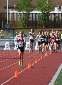 Kenai Central senior Allie Ostrander leads the field around at the conclusion of the first lap in Friday's 4A girls 3,200 meter race at the Alaska state track and field meet at Dimond Alumni Field in Anchorage.