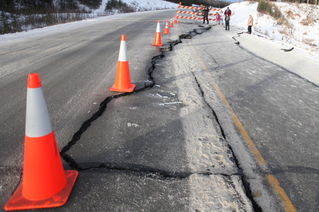 Kenai Police block off the entrance to Lilac Lane from the Kenai Spur Highway on Sunday, Jan. 24, 2016, in Kenai, Alaska. A 7.1 magnitude earthquake was felt on the peninsula and caused gas explosions in homes along Lilac Lane.