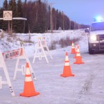 Enstar Natural Gas personnel work at the intersection of Lilac Lane and the Kenai Spur Highway after shutting off the area's gas supply on Sunday, Jan. 24, 2016 in Kenai, Alaska. A 7.1 magnitude earthquake caused gas explosions in four houses along Lilac Lane.