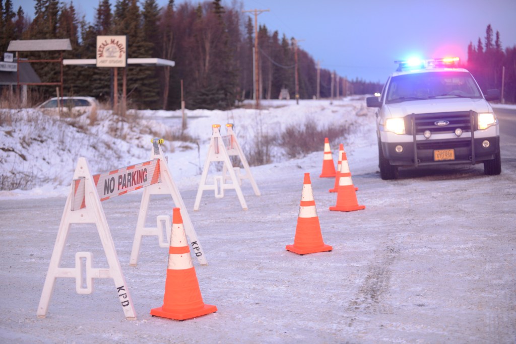Enstar Natural Gas personnel work at the intersection of Lilac Lane and the Kenai Spur Highway after shutting off the area's gas supply on Sunday, Jan. 24, 2016 in Kenai, Alaska. A 7.1 magnitude earthquake caused gas explosions in four houses along Lilac Lane.