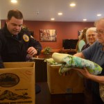 Lt. Dane Gilmore of the Alaska State Troopers accepts 26 hand-made quilts from a group of crafters on Thursday, March 11, 2016 at Northwood Apartments in Soldotna, Alaska. Through several cooperating agencies, the blankets are given out to children in need or involved in investigations.