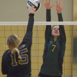 Nikiski's Ayla Pitt (10) and Jamie Yerkes team up to block a shot by Mt. Edgecumbe hitter Haylee Steffes (15) Friday evening at the Class 3A state volleyball tournament held at the Alaska Airlines Arena in Anchorage.