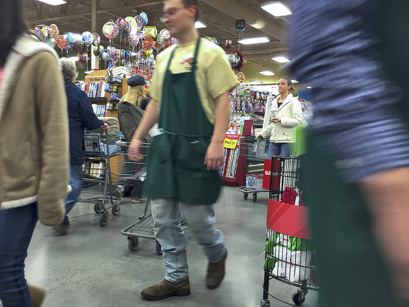 Colette Scott helps a customer check out at Northcountry Fair on Friday Nov. 27, 2015 during a Black Friday sale in Soldotna, Alaska.