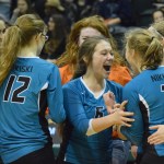 Seward libero Kimmie Hubbard (in pink) digs for a ball with teammate Tia Miranda, Friday against Monroe Catholic in the Class 3A state volleyball tournament held at the Alaska Airlines Arena in Anchorage.