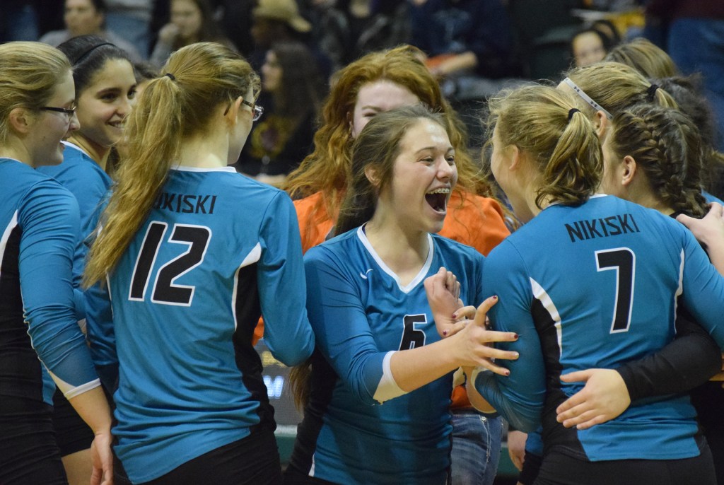 Seward libero Kimmie Hubbard (in pink) digs for a ball with teammate Tia Miranda, Friday against Monroe Catholic in the Class 3A state volleyball tournament held at the Alaska Airlines Arena in Anchorage.