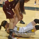 Homer senior Madison Akers grapples for the ball with a Mt. Edgecumbe player in Friday's Class 3A girls state semifinal at the Alaska Airlines Center in Anchorage.