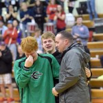 Maj. Josh Pead (right) embraces his sons Nick and Cameron in an emotional hug before Thursday night's varsity boys basketball game at Kenai Central High School. Pead, a physican in the Army, made a surprise appearance after returning from a six-month military deployment in the Middle East. (Photo by Jeff Helminiak/Peninsula Clarion)