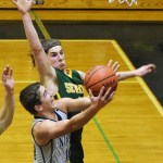 Nikiski&rsquo;s Ian Johnson drives to the rim against Seward defender Nik Pahno in a Friday night matchup at Nikiski High School. (Photo by Joey Klecka/Peninsula Clarion)