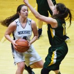 Nikiski&rsquo;s Emma Wik works to find a way around Rose Terry of Seward in a Southcentral Conference meeting Friday night at Nikiski High School. (Photo by Joey Klecka/Peninsula Clarion)