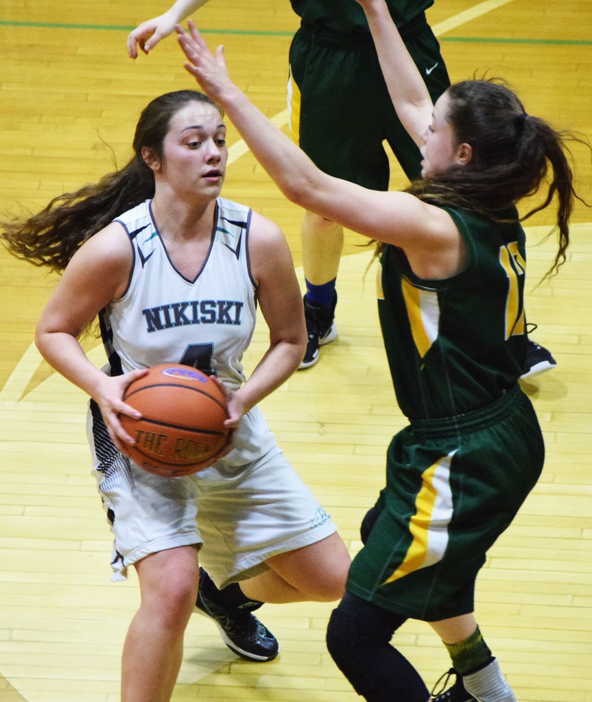 Nikiski&rsquo;s Emma Wik works to find a way around Rose Terry of Seward in a Southcentral Conference meeting Friday night at Nikiski High School. (Photo by Joey Klecka/Peninsula Clarion)