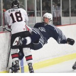 Soldotna skater Alois Neunzert gets checked by Kenai Central&rsquo;s Jakeb O&rsquo;Brien (18) Saturday night at the Kenai Multipurpose Facility. (Photo by Joey Klecka/Peninsula Clarion)