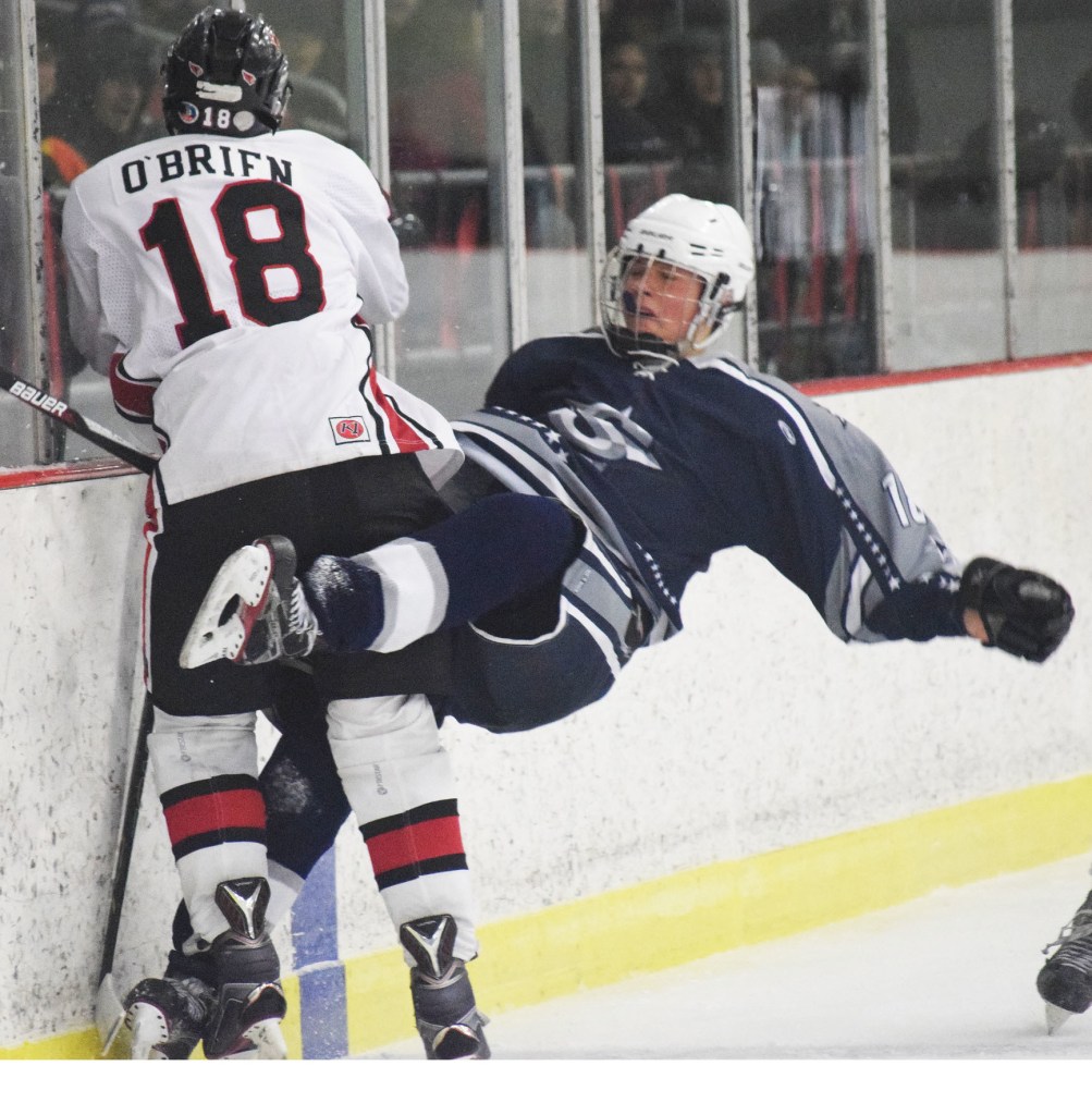 Soldotna skater Alois Neunzert gets checked by Kenai Central&rsquo;s Jakeb O&rsquo;Brien (18) Saturday night at the Kenai Multipurpose Facility. (Photo by Joey Klecka/Peninsula Clarion)