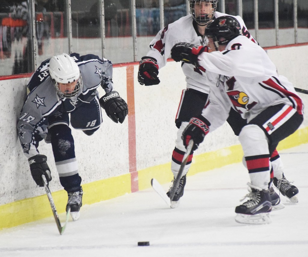 Soldotna skater Alois Neunzert keeps his balance along the boards against Kenai Central on Saturday night at the Kenai Multipurpose Facility. (Photo by Joey Klecka/Peninsula Clarion)