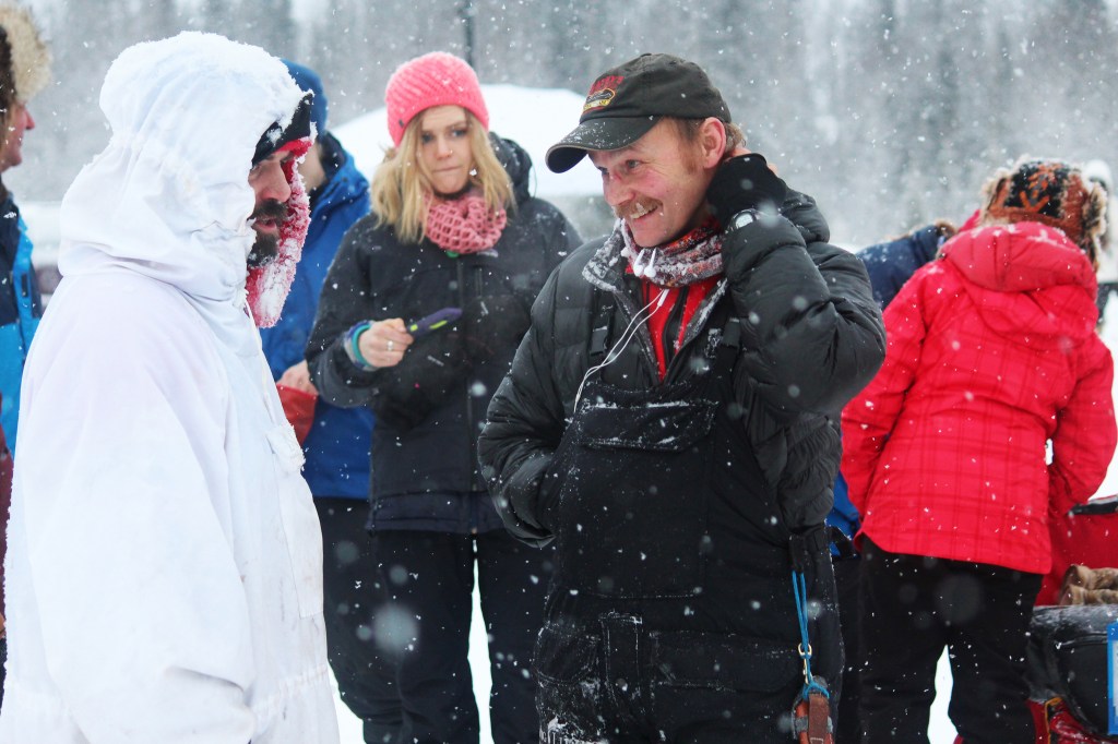 Cim Smyth (left) and Nicolas Petit share a high-five after coming in first and second, respectively, at this year's Tustumena 200 Sled Dog Race on Sunday, Jan. 29, 2017 in Kasilof, Alaska. The pair finished just three minutes apart after a 200-mile race through the Caribou Hills. (Megan Pacer/Peninsula Clarion)