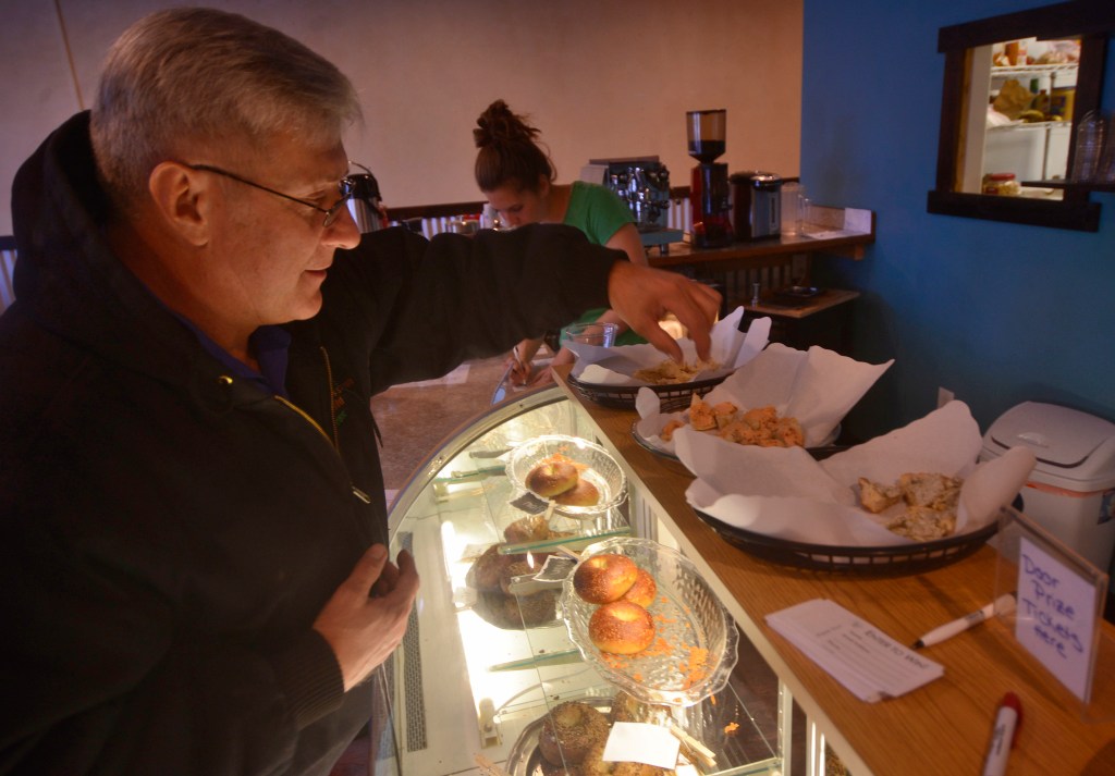 Jeff Warton samples three flavors of bagel spread at the grand opening of the Kenai location of Everything Bagels on Tuesday, Jan. 31,2017 in Kenai, Alaska. The grand opening comes 13 days after the Kenai shop had its soft opening on Jan. 18, seven months after Everything Bagels opened its first location in Soldotna on July 15, 2016, and on the one-year anniversary of co-owners Matt and Pamela Parker (with Brooke and John Campbell) making their first batch of bagels in their home kitchen, Pamela Parker said. "We came from Florida, where all the New Yorkers go to retire, so there's tons of delicious bagels there," she said. "We wanted to bring that up here." (Ben Boettger/Peninsula Clarion)
