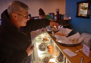 Jeff Warton samples three flavors of bagel spread at the grand opening of the Kenai location of Everything Bagels on Tuesday, Jan. 31,2017 in Kenai, Alaska. The grand opening comes 13 days after the Kenai shop had its soft opening on Jan. 18, seven months after Everything Bagels opened its first location in Soldotna on July 15, 2016, and on the one-year anniversary of co-owners Matt and Pamela Parker (with Brooke and John Campbell) making their first batch of bagels in their home kitchen, Pamela Parker said. "We came from Florida, where all the New Yorkers go to retire, so there's tons of delicious bagels there," she said. "We wanted to bring that up here." (Ben Boettger/Peninsula Clarion)