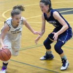 Nikiski&rsquo;s Bethany Carstens drives on Soldotna&rsquo;s Danica Schmidt on Tuesday, Jan. 31, 2017, at Nikiski High School. (Photo by Jeff Helminiak/Peninsula Clarion)
