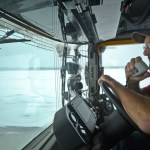 Equipment operator Terry Russ drives a broom machine up and down the runway of the Kenai Municipal Airport on Monday, Feb. 13, 2017 in Kenai, Alaska. Russ had been at work since 4 a.m doing what he called &ldquo;probably the most monotonous job on the airport&rdquo; to keep the runway clear of snow that could soldify into ice. On heavy snow days, two broom machines drive down each side of the runway centerline, whirling away snow with heavy rotary brushes while a plow truck scrapes off packed snow and ice. (Ben Boettger/Peninsula Clarion)