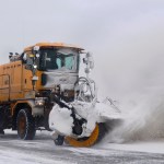 Two broom machines clear snow from in front of the Kenai Municipal Airport terminal on Monday, Feb. 13, 2017 in Kenai, Alaska. (Ben Boettger/Peninsula Clarion)
