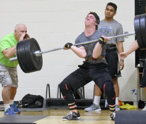Rykker Riddall, then a Kenai sophomore, sets the record in the Freshmen/Sophomore Clean in March 2016 in the Speed and Strength Training competition. At left, yelling encouragement, is Riddall&rsquo;s father, Ted Riddall. Ted Riddall will take over as Kenai Central&rsquo;s football coach next season. (Photo by Jeff Helminiak/Peninsula Clarion)