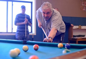 In the final game of the Kenai Senior Olympics pool tournament, Max Pitts watches his shot while his opponent, last year&rsquo;s champion Ken Losser, rests in the background on Tuesday, Feb. 21, 2017 at the Kenai Teen Center in Kenai, Alaska. Losser won, remaining undefeated in this year&rsquo;s 8-player double elimination competion, though narrowly &mdash; Pitts scratched on the eight ball. The 13th annual Senior Olympics will continue until Saturday with events including poker, pinochle, ping-pong, darts, dominoes, cribbage, basketball, and Wii bowling. (Ben Boettger/Peninsula Clarion)