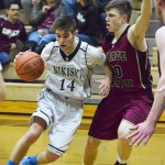 Nikiski guard Garrett Ellis (14) makes a move against Grace Christian defender Tobin Karlberg, Friday night at Nikiski High School. (Photo by Joey Klecka/Peninsula Clarion)