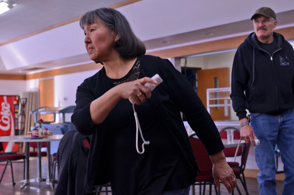 Marcia Whitworth (left) swings a controller to toss a virtual bowling ball during a game of Nintendo Wii bowling during the 13th annual Kenai Peninsula Senior Olympics at the at the Soldotna Senior Center on Saturday, Feb. 25, 2017 in Solodotna, Alaska.