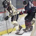 Kenai River defenseman Alex Dingeldein and Minnesota forward Dmytro Kobylyanskyi battle for the puck behind the net Friday, March 3, 2017, at the Soldotna Regional Sports Complex. (Photo by Jeff Helminiak/Peninsula Clarion)