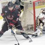 Minnesota Magicians forward Nikita Kozyrev tries to keep the puck away from Brown Bears defenseman Connor Fedorek and goalie Colt Hanks on Friday, March 3, 2017, at the Soldotna Regional Sports Complex. (Photo by Jeff Helminiak/Peninsula Clarion)