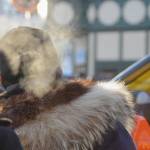 A spectator cranes over the crowd near the starting line at the ceremonial start of the 45th Iditarod sled dog race Saturday, March 4, 2017 in Anchorage, Alaska. The Iditarod is the culmination of a week-long festival called the Fur Rondy, a celebration of the end of the trapping season when, historically, trappers would come to Anchorage to auction off their furs. Many people in the crowd wore different types of fur, from lined kuspuks to fox-fur hats. (Elizabeth Earl/Peninsula Clarion)